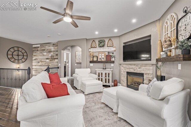 kitchen featuring a large island with sink, dark wood-type flooring, wall chimney range hood, and stainless steel appliances