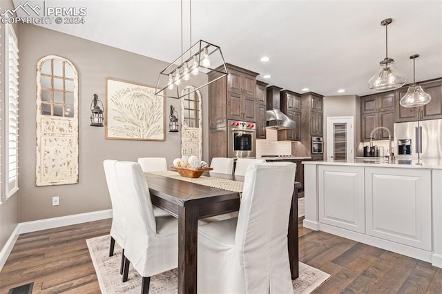 dining space with dark hardwood / wood-style floors and sink