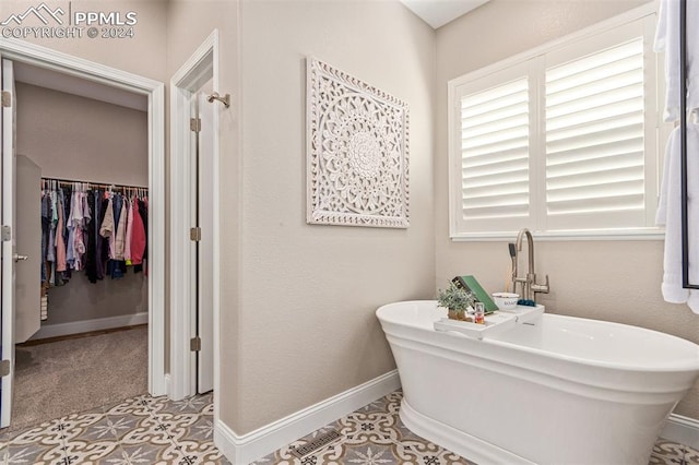 bathroom featuring a bathtub and tile patterned flooring