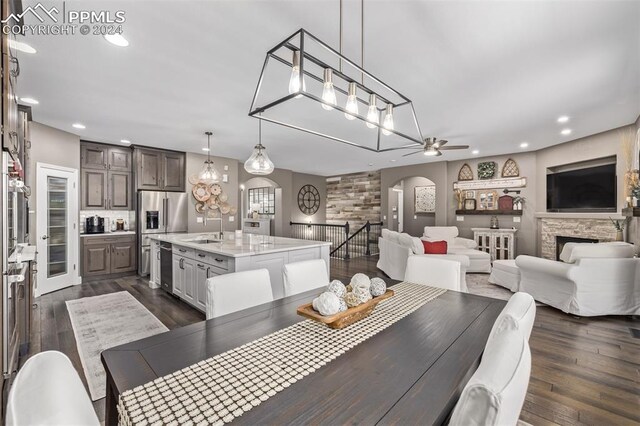 carpeted home office with wooden walls and ceiling fan