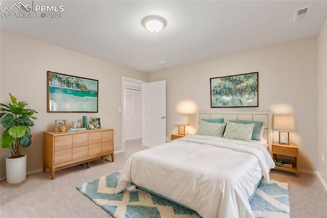 bedroom featuring light carpet