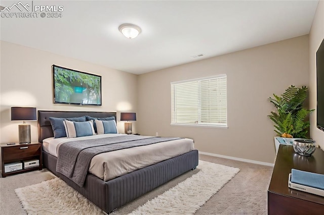 bedroom featuring light colored carpet