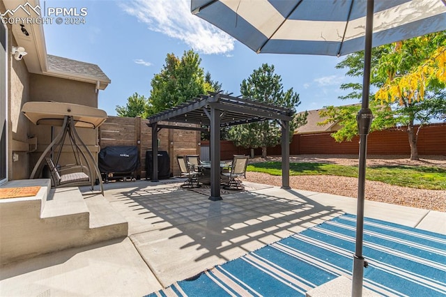 view of patio with grilling area and a pergola