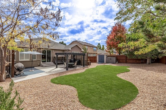 view of yard with a patio area, a storage shed, and a pergola