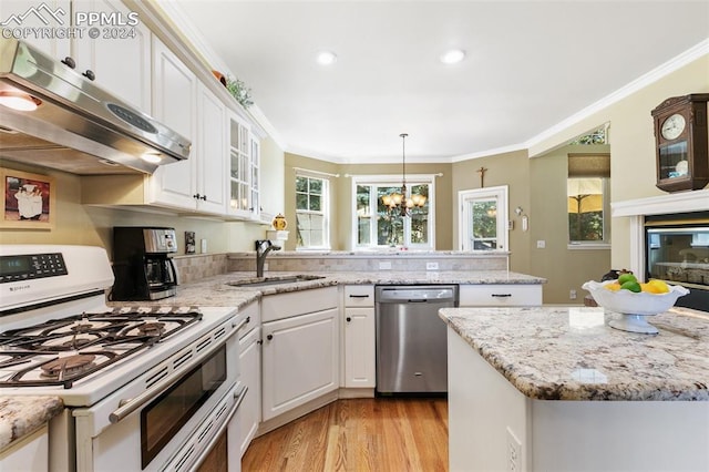 kitchen with sink, white gas range, white cabinetry, dishwasher, and a notable chandelier