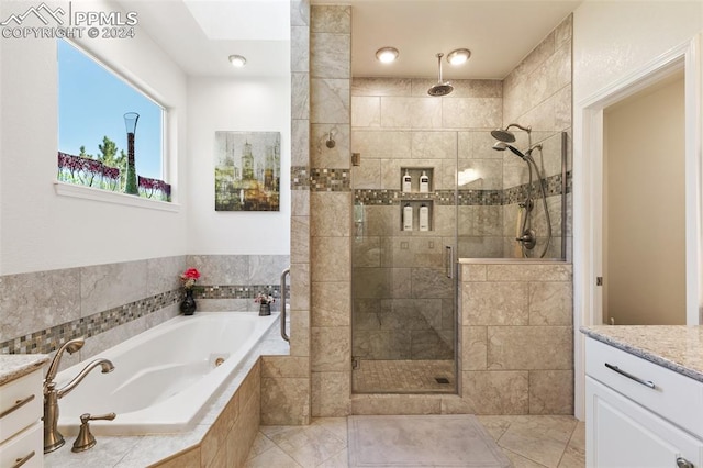 bathroom featuring vanity and separate shower and tub