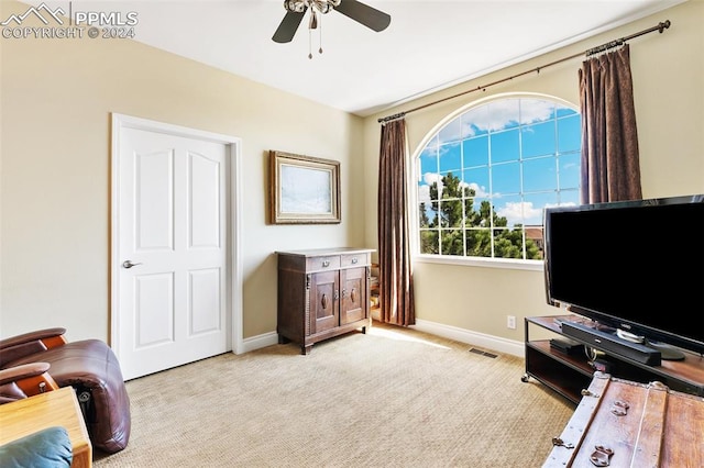 sitting room with lofted ceiling, ceiling fan, and light colored carpet