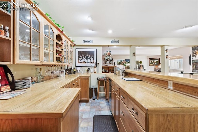 kitchen featuring kitchen peninsula and wood counters