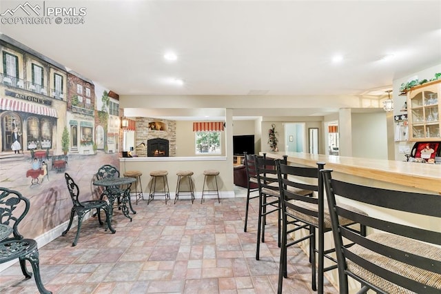 dining space featuring a fireplace and bar area