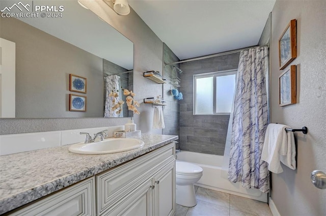 full bathroom with shower / bath combo with shower curtain, tile patterned floors, toilet, and vanity