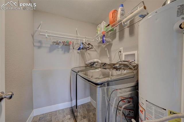 laundry room featuring gas water heater and washer and dryer