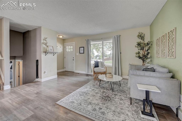 living room featuring a textured ceiling and hardwood / wood-style flooring