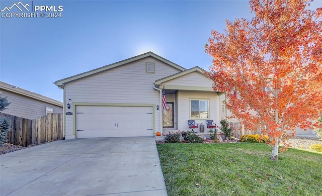 single story home with a front yard and a garage