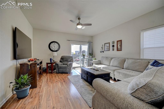 living room with light hardwood / wood-style floors and ceiling fan