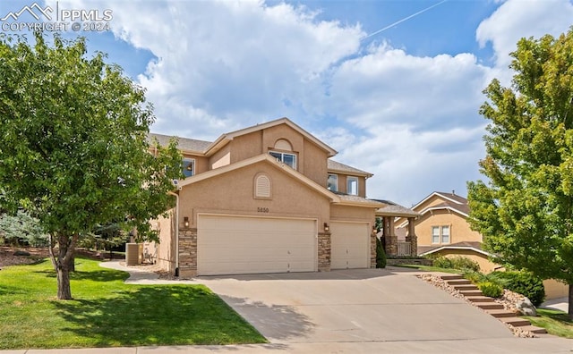 front of property featuring a front yard and a garage