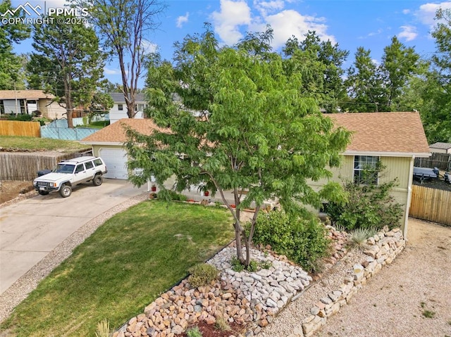 ranch-style home with a garage and a front yard