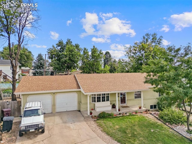 ranch-style home with a garage and a front yard