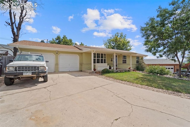 single story home featuring a garage and a front lawn