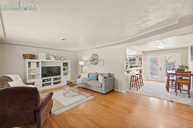 living room featuring light hardwood / wood-style flooring and french doors