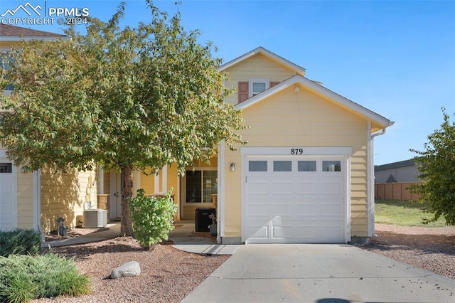 view of front of home featuring cooling unit and a garage