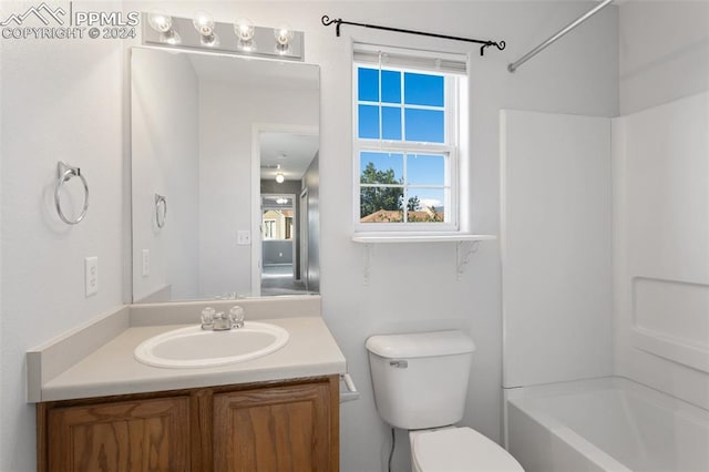 full bathroom featuring vanity, toilet, and  shower combination