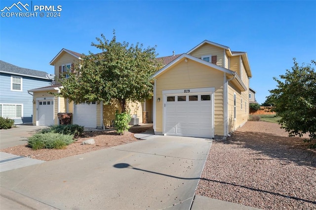 front of property with a garage and central AC