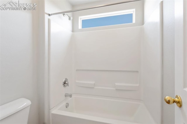 bathroom featuring shower / bathtub combination and toilet