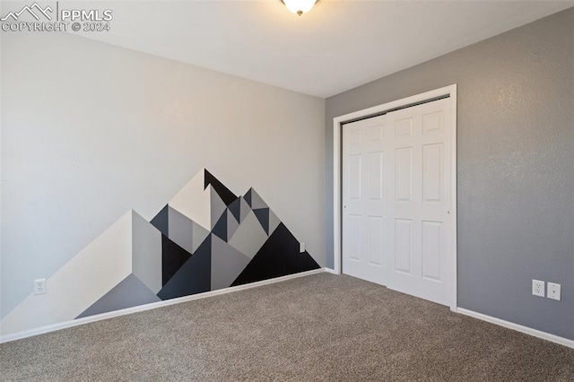 unfurnished bedroom featuring a closet and carpet