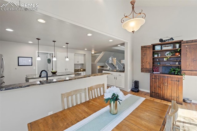 dining space with light hardwood / wood-style floors