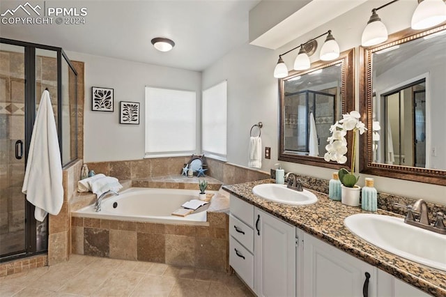 bathroom featuring tile patterned flooring, shower with separate bathtub, and vanity