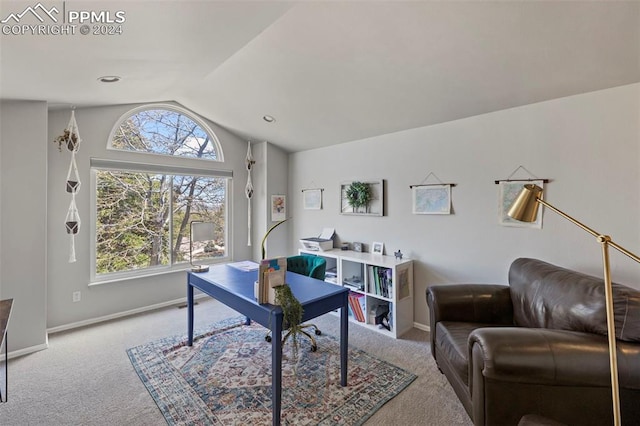 carpeted home office with lofted ceiling