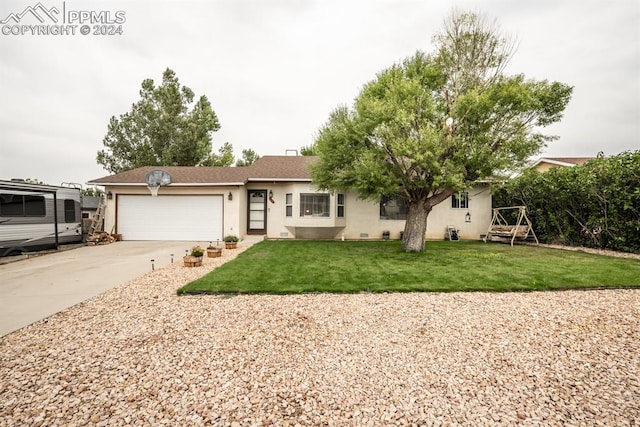 view of front of home with a garage and a front lawn