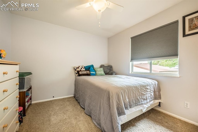 bedroom featuring light colored carpet and ceiling fan