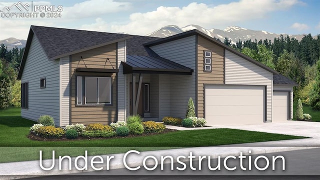 view of front of home featuring a garage, a mountain view, and a front yard