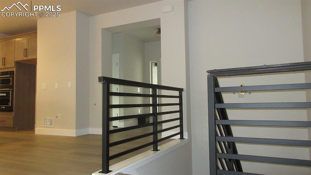 staircase featuring wood-type flooring