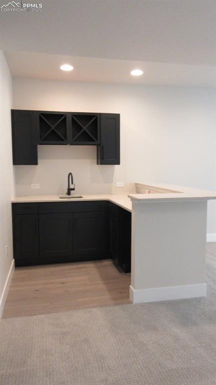 kitchen with light hardwood / wood-style floors and sink