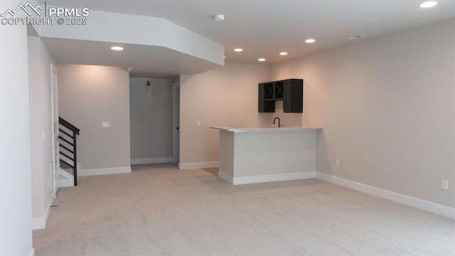 unfurnished living room featuring light colored carpet