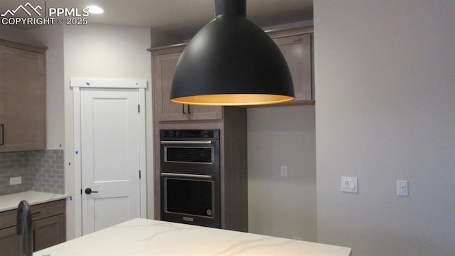 kitchen with double oven and backsplash