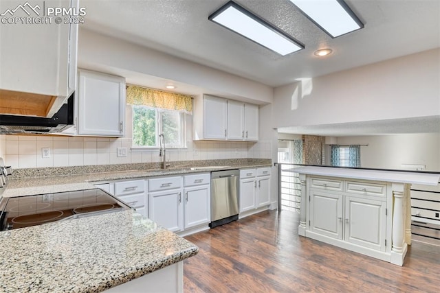 kitchen featuring stove, tasteful backsplash, stainless steel dishwasher, dark wood-type flooring, and white cabinets