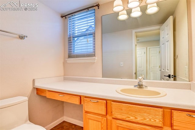 bathroom featuring tile patterned flooring, vanity, and toilet