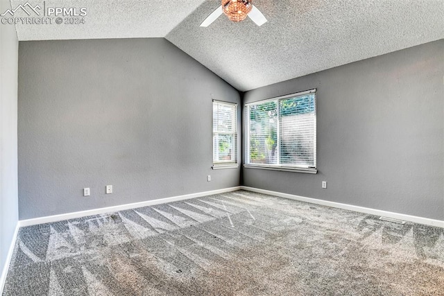 unfurnished room featuring carpet, ceiling fan, a textured ceiling, and vaulted ceiling