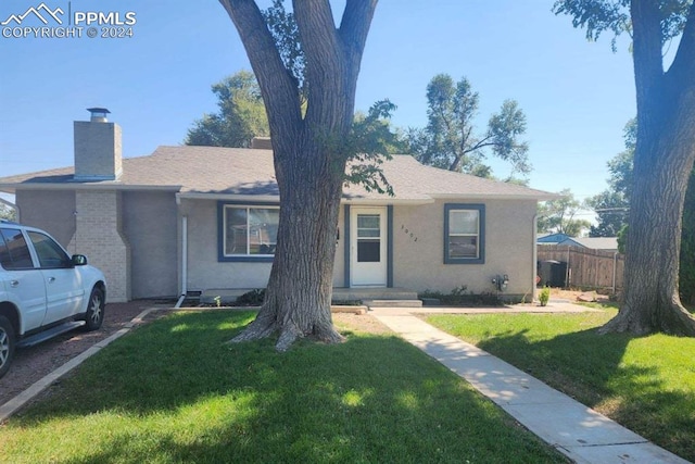 ranch-style house with a front lawn