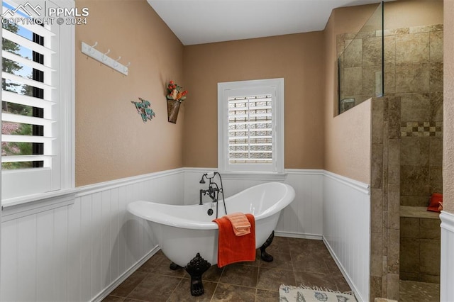 bathroom with independent shower and bath and tile patterned floors