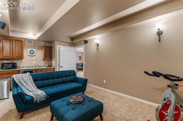 living room with bar and light carpet