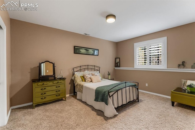 bedroom featuring light carpet