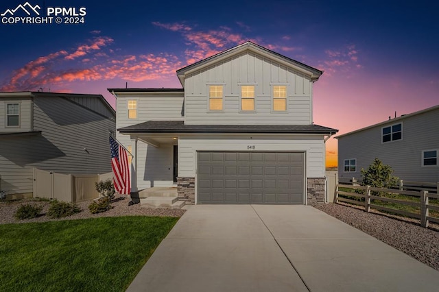 view of front of house with a yard and a garage