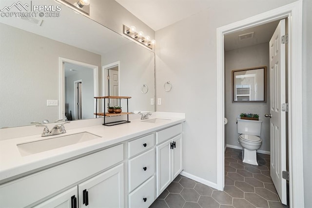 bathroom with tile patterned floors, vanity, and toilet