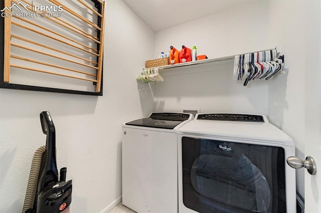 clothes washing area featuring washing machine and clothes dryer