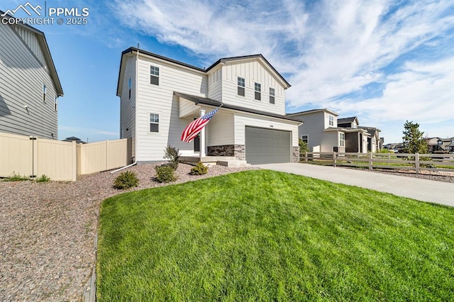 view of front of house with a front yard and a garage