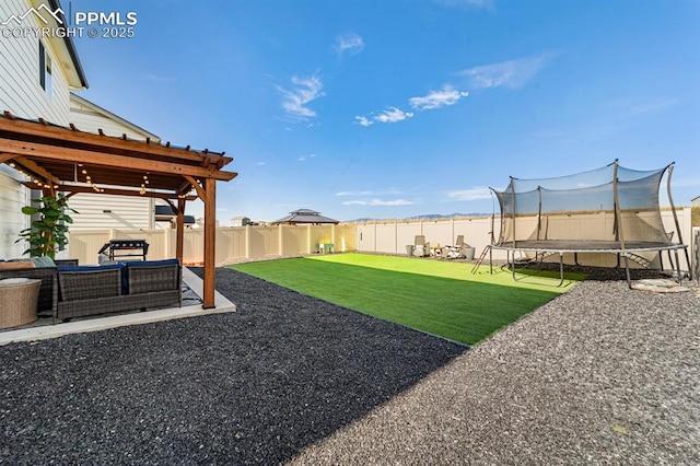 view of yard with a patio and a trampoline